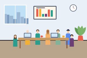 A team seated around a conference table with a chart on the wall