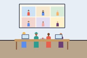 A meeting room with a wall screen showing remote participants