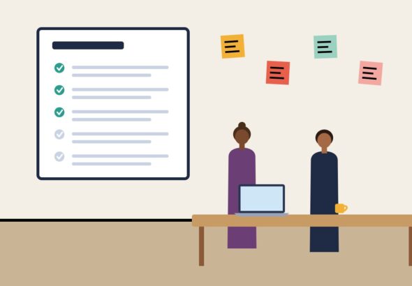A checklist and sticky notes beside a laptop after a meeting
