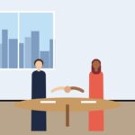 Two professionals shaking hands across a table