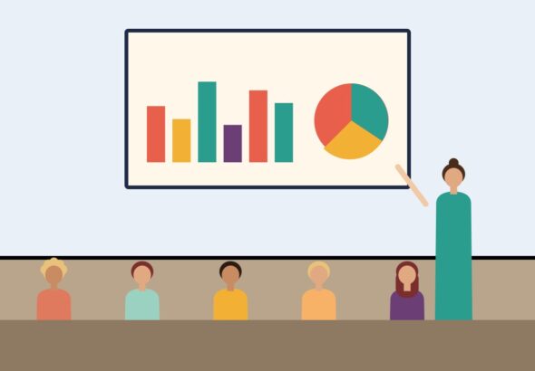 A presenter explaining charts to an attentive audience